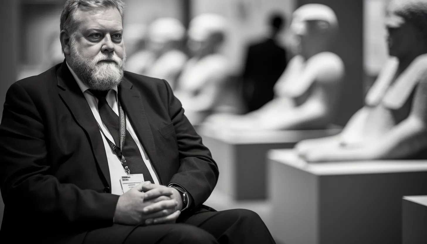 A black and white shot of Hartwig Fischer, the now-former director of the British Museum, looking thoughtful with the museum's interior blurred in the background to symbolize his resignation amidst chaos, taken with a Nikon D850.