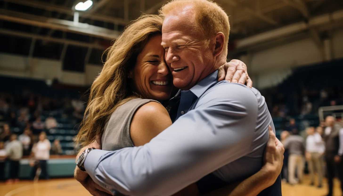 Coach Joe Kennedy and his wife, Denise, embracing each other after his triumphant return to coaching, taken with a Sony A7R III