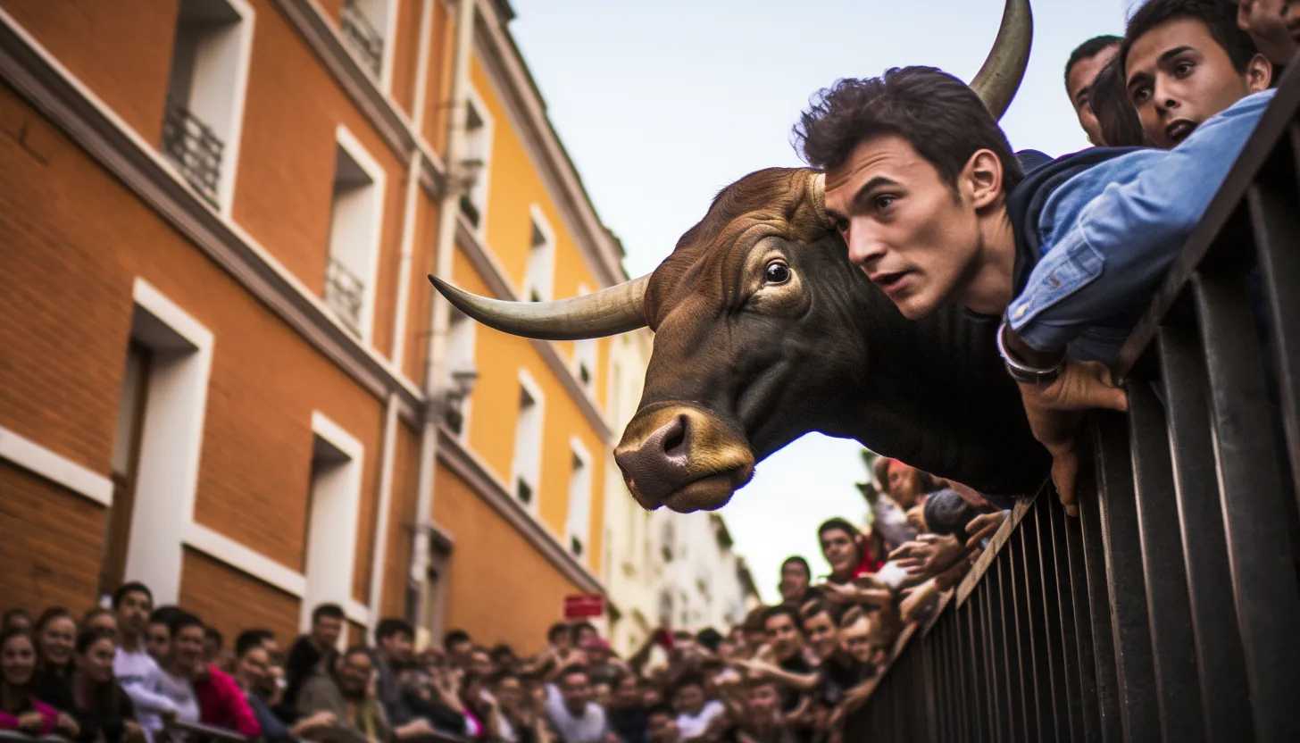 A crowd gathering in anticipation, as people climb barriers and walls for a better view of the impending bull-running event. A sense of excitement and fear permeating the atmosphere. (Taken with Nikon Z7 II)